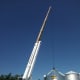 Here you can see why the wheels and bigger outriggers make this crane more stable than most boom trucks. It is lifting a 4,000 bushel bin (18-foot diameter) in preparation for setting it onto a hopper.