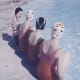 four vintage swimmers with swim caps