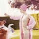 lady wearing a pink swim cap, pink robe and white one piece swim suit feeding a treat to a dog who is jumping up for the treat