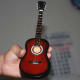 Classic miniature guitar in palm hand