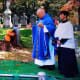 Throwing dirt at people crying at a funeral.