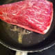 Brown both sides in a frying pan before placing the meat on the barbecue