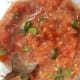 Two tomatoes after 6 seconds. (sliced green onion stirred in afterwards). On its way to salsa.