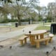 View of picnic tables, pavilion, rock climbing wall and lake in Bane Park