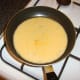 Beaten eggs are poured in to omelette pan