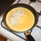 Poached chicken is laid on one half of omelette