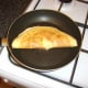 Omelette is carefully folded over