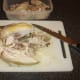 First breast fillet is removed from poached chicken