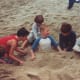 Jason's friends burying him in the sand at one of the numerous beach birthday parties at Sycamore Cove State Beach
