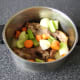 The pheasant carcasses and chopped vegetables are added to a large stock pot