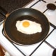 Egg is fried in the juices of the pork chop