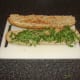 Rocket leaves/arugula is firstly laid on the bottom half of the bread