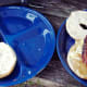 When the eggs are done, divide the patties and place onto bagels. Top with the bacon.