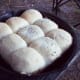 Take the rolls out of their foil pan and place into skillet. Cover before putting them on the coals.