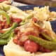 Chili hot dogs with peppers, onions and smoked Gouda cheese on the side.