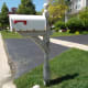 Use a pressure washer to strip off loose paint from a mailbox post