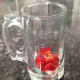 1. Fill bottom of clear glass or mug with diced strawberries.