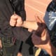 Applying a wrist lock and using the pen at the hinge point inside the elbow to gain leverage for a throw.