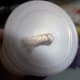 Knotting the wick at the bottom of the cup