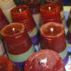 Batches of coloured candles made from plastic cup moulds.