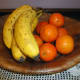 Plaited wooden with oranges and bananas