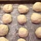 Place the cut biscuits on floured pans while waiting to fry them.