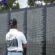 My husband at the wall viewing the names of his friends