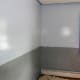 The blue and gray paint have been applied. Since a border will cover the line, we did not use painter's tape to create a neat edge.