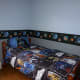 The wall border and bedding make a cheery, intergalactic room.