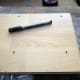 Drill the pilot holes in your thin piece of wood sheet to create a template for marking out drill fixing holes on your bathroom wall.