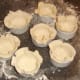 Puff pastry pie casings are fitted in to ramekins