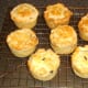 Mini haggis and clapshot puff pastry pies are rested on a wire rack