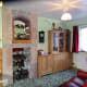 The old fireplace tiled and fitted with mirrored display shelves