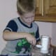 My great-nephew carefully measuring out sugar for a recipe.