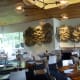 Main dining room with large windows to the right of the bar area