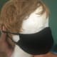 A side angle of a homemade double folded mask that is also described as keeping less respiratory particles from escaping.