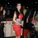 Kim Kardashian in a pretty red dress and high heels