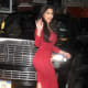 Kim Kardashian in curve hugging red dress and high heels
