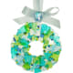 10. To complete the wreath I make a small bow that I attach with glue to the ribbon. For the pictured wreath I adhered two small cobbles to the bow, beads work well too. The ends of the ribbon were tied into an attractive knot for hanging. Beautiful!
