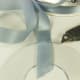 3. Cut a small slit the width of your ribbon along the base of the hanging tab following the curve of the circle. Insert the ribbon pulling it through until both ends are equal in length. It is important that the ribbon be added before you glue on th