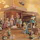 beautiful Hummel Nativity Set in soft pastels complete with wooden manger and porcelain star and angle above the manger