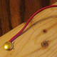 Attachment of the bare wire from one free end of the electromagnet to the thumb tack.