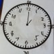 Once we had the hours and minutes in place, I called out a time and he wrote the hour and minute hands on the clock. I took these pictures.