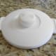 The lid has clamps on the side which seal the lid to the pot. The cap rotates to open the air vents.