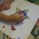 Sprinkling on the tissue paper pieces.