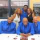 The Intruders sign autographs as they take a photo with my twin sister Paulette and I.