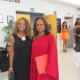 Sheila, greets Paulette, my sister at event for a photo.