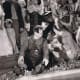 Stan Laurel offers Oliver Hardy some water after Hardy almost drowned.