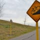 A sign near the large hill