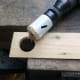 Hole cut in the test piece, to test fit the drinking horn and help determine the desired length for the stand.